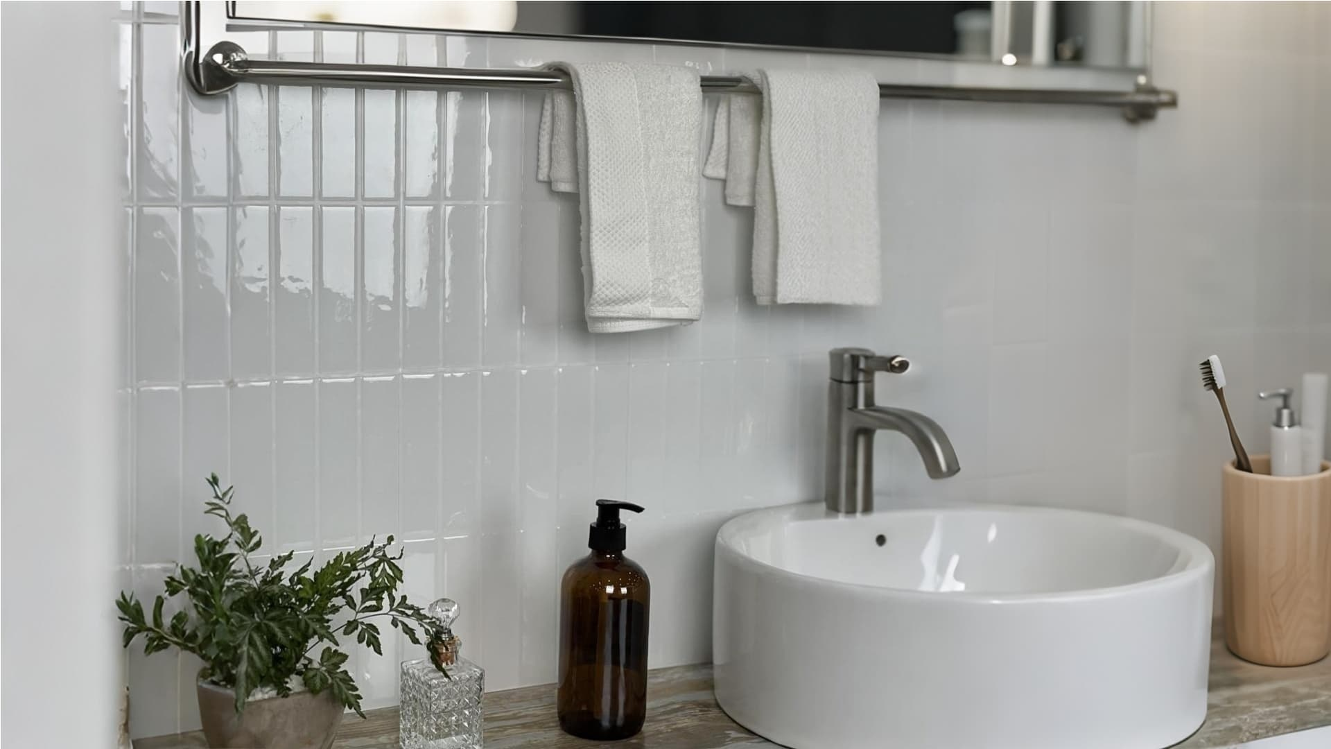 Stickwoll Tiles Snowy Ceramic Peel and Stick Tiles in a modern bathroom with white subway tiles, stylish towel rack, and natural decor elements for a clean, minimalistic look.