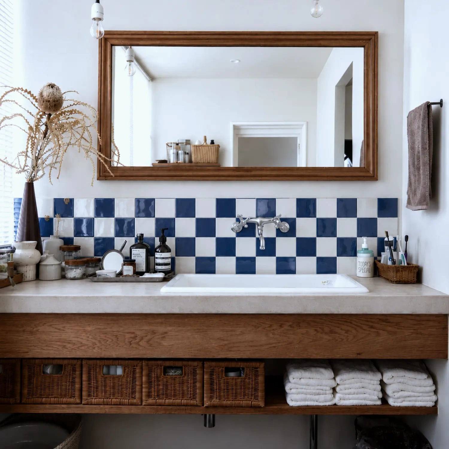 Coastal Breeze blue and white checker peel and stick tiles in a warm coastal bathroom vanity backsplash