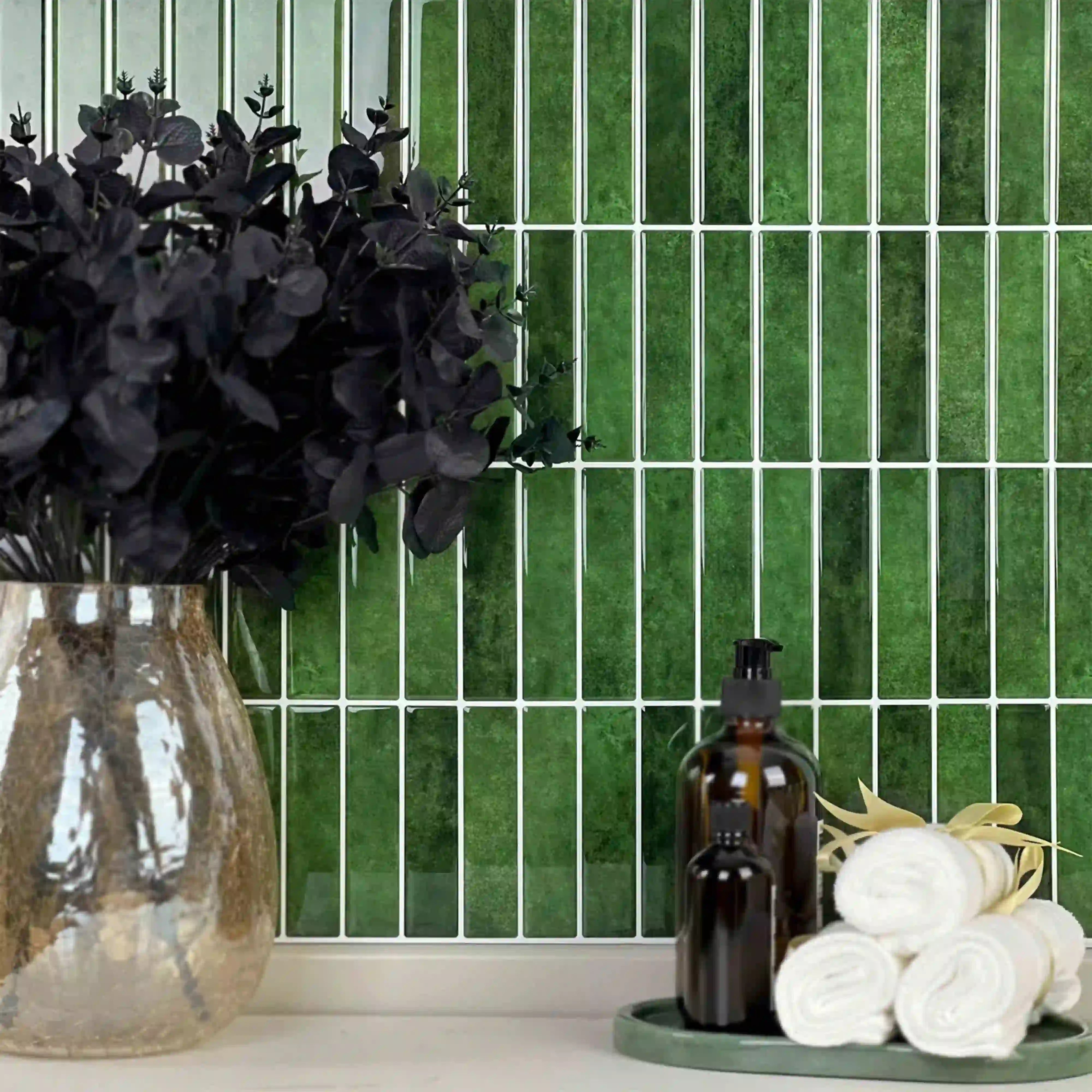 Stickwoll Peel and Stick Gradient Strips Tiles series displayed in a minimalist bathroom; featuring Minty Ceramic Tiles on the wall, styled with a brown vase holding greenery, a towel, and a tray for a fresh and elegant decor