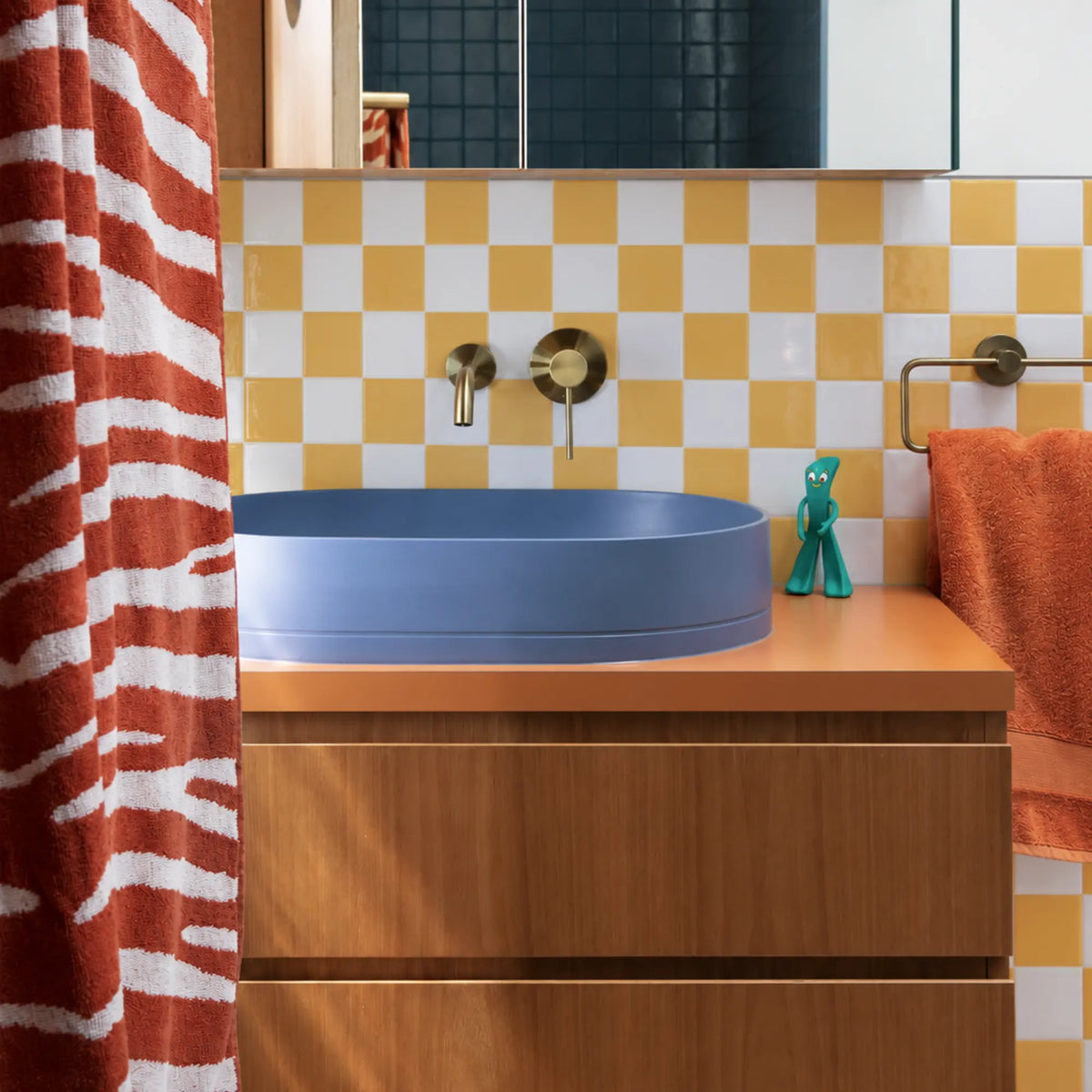 Colorful bathroom vanity with blue vessel sink and Primrose Courtyard yellow checkerboard peel and stick wall tiles