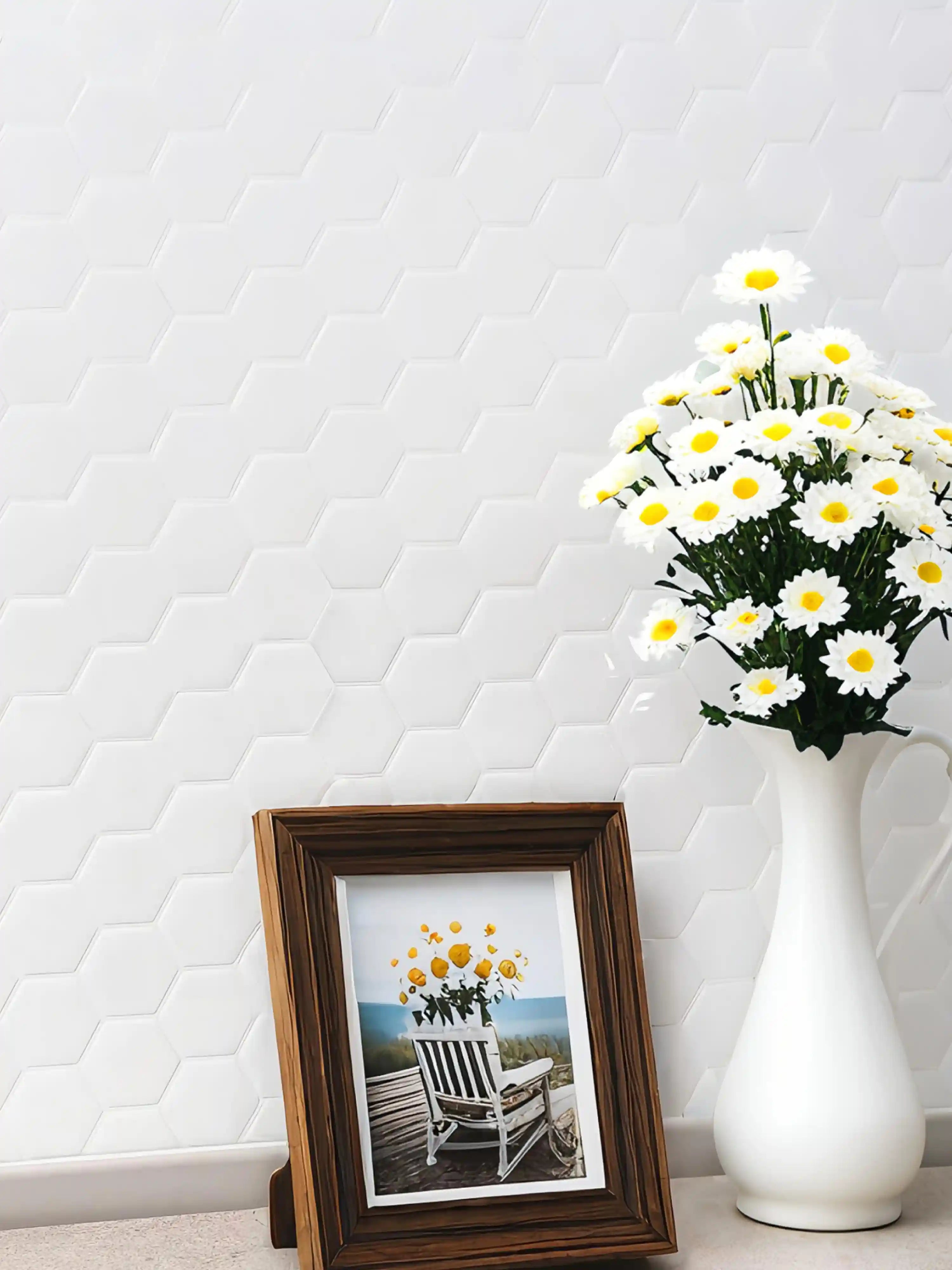 Stickwoll Peel and Stick Hexagon Tiles series showcased in a minimalist kitchen; featuring Ivory Hexagons Tiles on the wall, styled with a photo frame and white flowers and vases and modern aesthetic