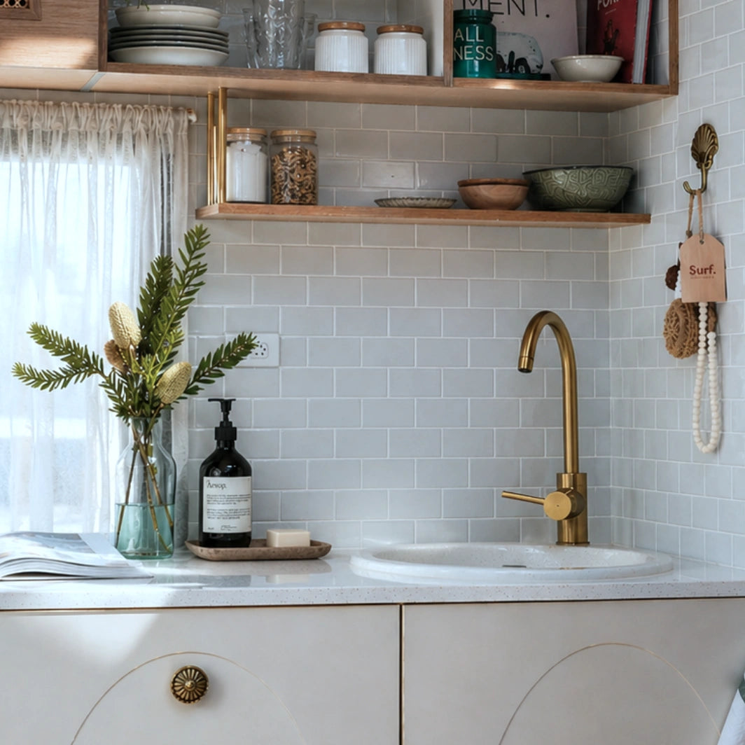 Misty Subway peel and stick tiles kitchen backsplash, glossy light blue subway tiles, cozy Scandinavian kitchen sink corner with brass faucet