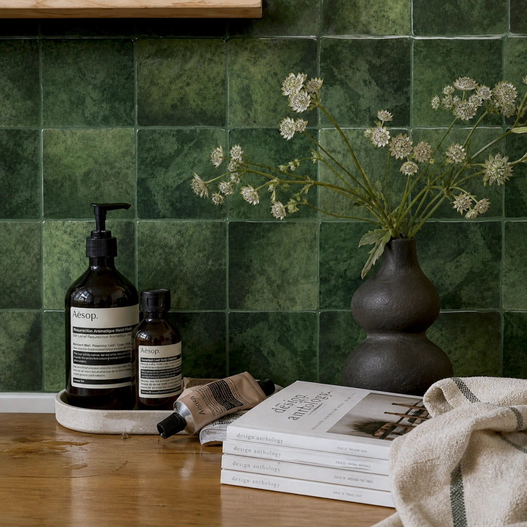 Olive Squares peel and stick tiles bathroom wall, glossy dark green square tiles, luxury spa-inspired countertop styling with natural decor