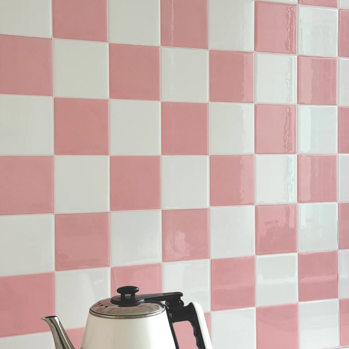 Peach Shore pink and white checkerboard peel and stick tile backsplash with a glossy finish in a kitchen corner